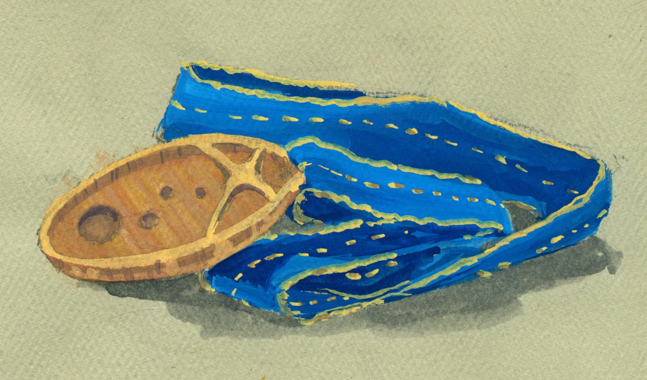 A bronze-gold medal on a bright blue ribbon. The medal has a flattened X over a trail of craters.